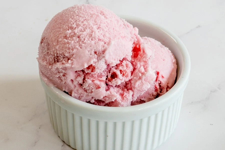 pink ice cream in white cup